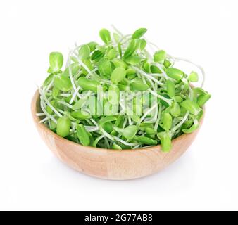 Sunflower sprout in wooden bowl isolated on white background Stock Photo