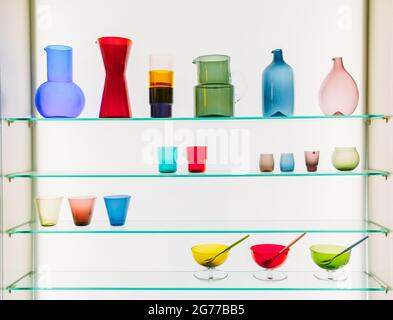 Assorted Different Sizes And Shapes Of Colorful Glassware On Shelves. Vases, Pitchers, Jugs, Glasses. Stock Photo