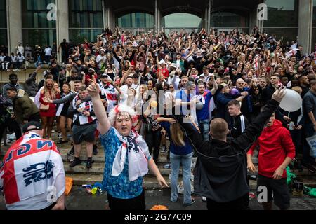 Manchester, UK. 11th July, 2021. People gather in Spinningfields to watch the match from any location that a screen can be seen. Credit: Andy Barton/Alamy Live News Stock Photo