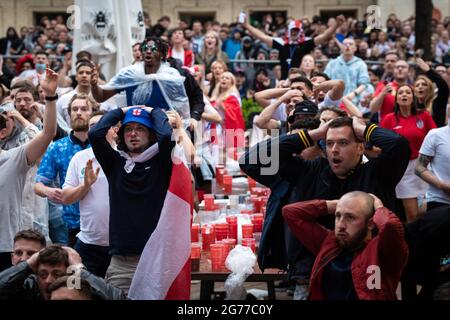 Manchester, UK. 11th July, 2021. Intense scenes down Spinningfields during the Euro2020Final which saw England get beaten by Italy during penalties. Football fans descended into the city early to try and catch the game wherever they could.ÊAndy Barton/Alamy Live News Credit: Andy Barton/Alamy Live News Stock Photo