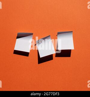 Blue sticky note paper on red background. copy space Stock Photo