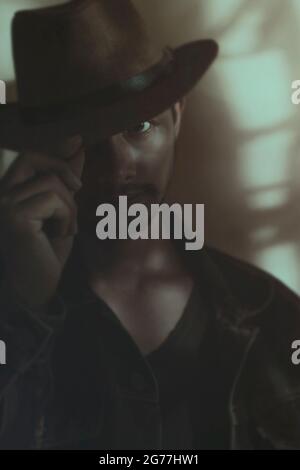 Cowboy men are attractive in thoughtful postures.under the light through the shadow of the trees Stock Photo