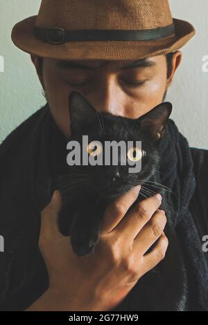 Cat's eyes look instead of human eyes.Love the relationship between two different lives.Still the same smell of life Stock Photo