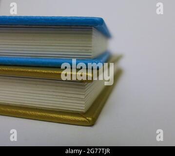 Stack of leather bound blue and gold books Stock Photo