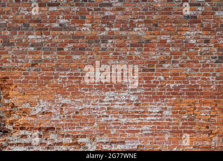 Front view of old and weathered red brick wall. Abstract full frame textured background. Stock Photo