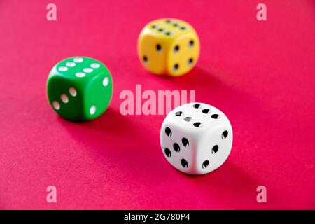 Three colorful dices isolated on pink background Stock Photo