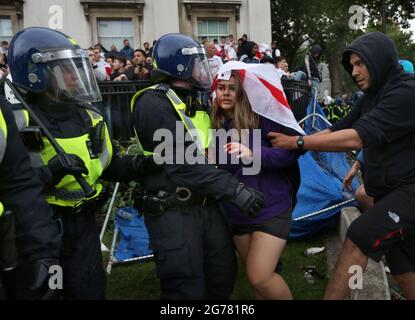 London, UK. 11th July, 2021. An injured fan makes her way to a police medic after she was hit by a missile during the celebration.England play Italy in the final of the Euro 2020 tournament. as Credit: SOPA Images Limited/Alamy Live News Stock Photo