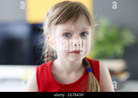 Portrait of little emotional girl with pensively frightened look closeup Stock Photo