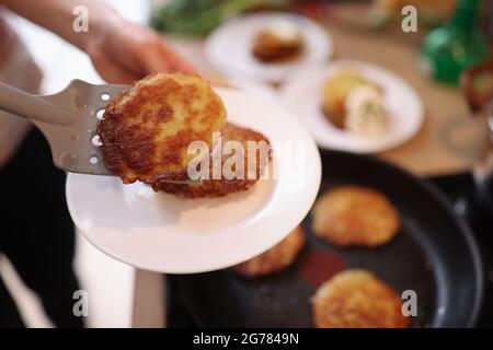 Fresh cooking potato pancakes in skillet closeup Stock Photo