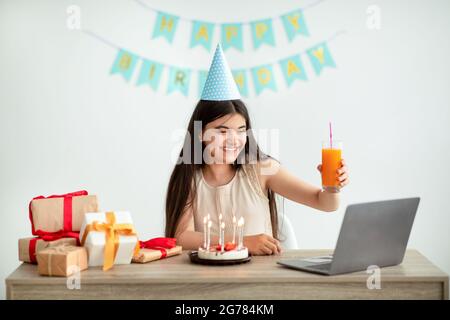 Indian teen girl having online birthday party from home during coronavirus lockdown, video conferencing with friends Stock Photo