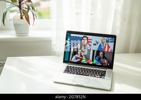 Back view of business woman talking to her colleagues in video conference business team using laptop for a online meeting in video call working from Stock Photo
