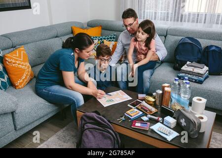 Mother explaining to her family the emergency assembly point Stock Photo