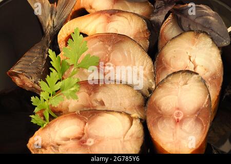 Mackerel, delicious pieces of smoked fish on a plate. close-up Stock Photo