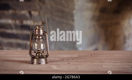 old gas lantern on wooden table with empty space Stock Photo