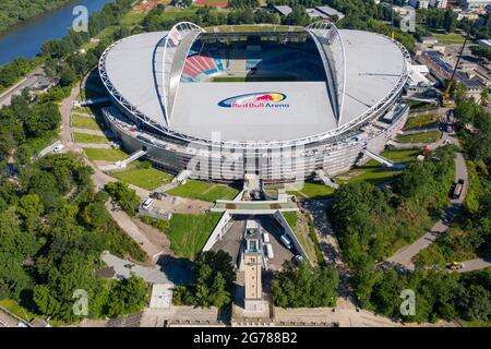 14 June 2021, Saxony, Leipzig: Two cranes stand at the Red Bull Arena. RB Leipzig's home ground is being rebuilt. The spectator capacity increases from 42,558 to 47,069 standing and seated. The outside of the stadium is enclosed with a soundproof facade. The embankment of the former Zentralstadion, which encompasses the arena, was cut open behind the historic bell tower to make room for a new entrance. RB Leipzig is investing a good 60 million euros in the conversion by 2022. (Aerial view with drone) Photo: Jan Woitas/dpa-Zentralbild/ZB - IMPORTANT NOTE: In accordance with the regulations of t Stock Photo