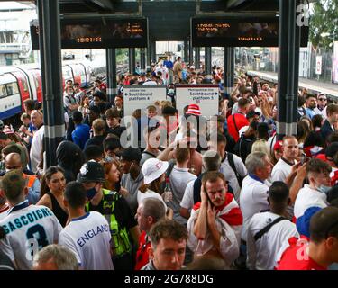 Wembley, London, UK. 12th July, 2021. The Wembley Park station is packed with people as they wait for the train to travel towards central London. 11/07/2021, Marcin Riehs/Pathos Credit: One Up Top Editorial Images/Alamy Live News Stock Photo