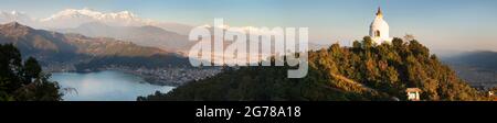 Evening panoramic view of world peace stupa, Phewa lake, Pokhara and great himalayan range, Annapurna, Manaslu, Nepal Himalayas mountains Stock Photo