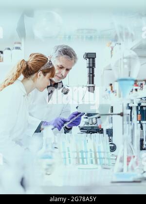 Health care researchers working in scientific laboratory. Stock Photo
