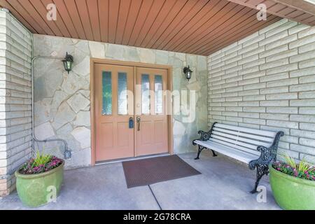 Glass paned double front door of house with modern lockbox for security Stock Photo