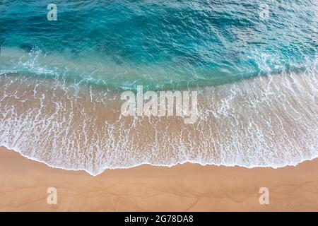 Abstract of beautiful soft wave come to beach background. Soft wave of blue sea on sand beach background. Stock Photo