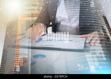 Businesswoman pointing her finger on a graph showing growth; multiple exposure Stock Photo