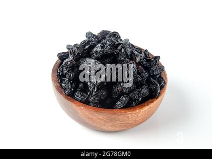 Black raisins in bowl.On white background