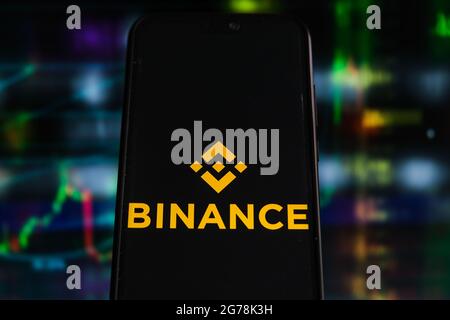 In this photo illustration a Binance logo seen displayed on a smartphone with stock market percentages in the background. (Photo by Omar Marques / SOPA Images/Sipa USA) Stock Photo
