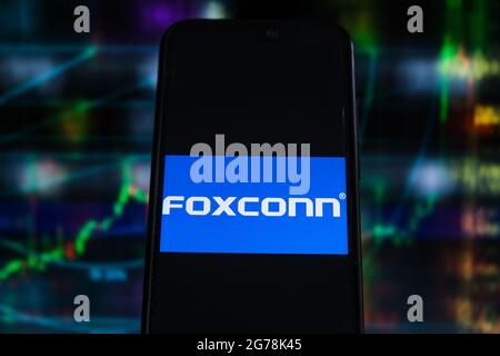 In this photo illustration a Foxconn logo seen displayed on a smartphone with stock market percentages in the background. (Photo by Omar Marques / SOPA Images/Sipa USA) Stock Photo