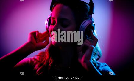 Young woman listens to music on her headphones Stock Photo