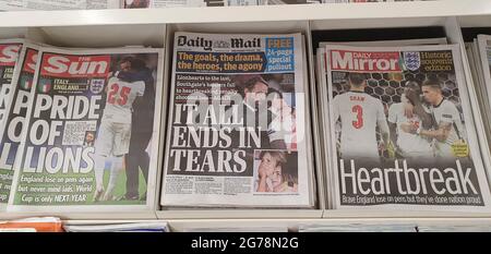 London, UK, 12 July 2021: Newspaper front pages cover England's defeat in the final of Euro 2020. The England men's football team lost on penalties to Italy at Wembley last night. The coverage emphases the disappointment but also the pride in the young at diverse team, who have sadly been subject to racial abuse online since the game. Many of the papers used photos of England manager Gareth Southgate consoling Bukayo Saka after his penalty attempt was saved by the Italian goalkeeper. Anna Watson/Alamy Live News Stock Photo