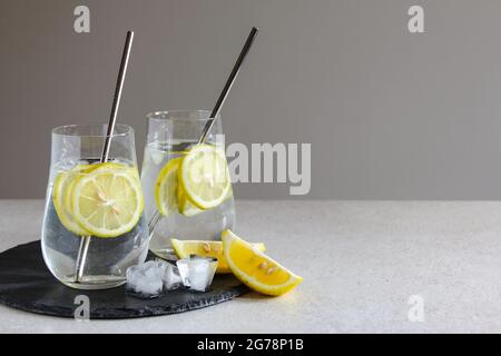 Cold drinks in small bottles. Cherries and lemon lemonade or cocktail. Stock Photo