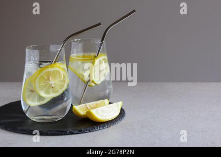 Cold drinks in small bottles. Cherries and lemon lemonade or cocktail. Stock Photo