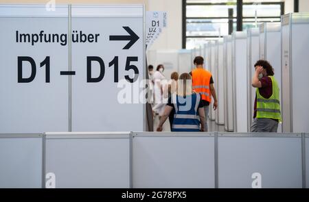 Munich, Germany. 12th July, 2021. Employees stand in the vaccination center at Messe München. Since 12.07.2021, students of graduating classes can also be vaccinated. Credit: Sven Hoppe/dpa/Alamy Live News Stock Photo
