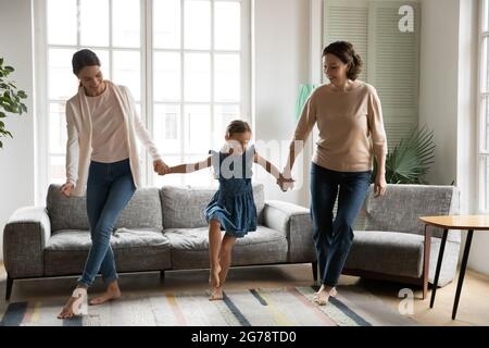 Happy three generations of women relax dancing together Stock Photo