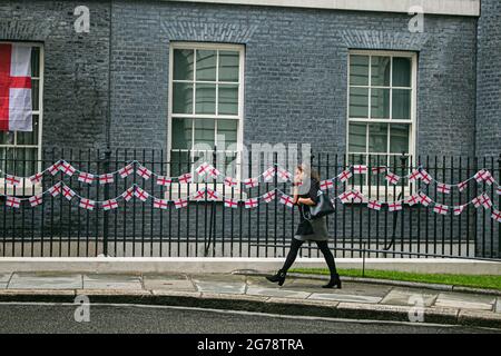 LONDON  12 July 2021. England bunting is attached to the railings at  Downing Street shortly they are  by staff after the defeat of the England national football  team which lost  the Uefa Euro 2020 final against Italy at Wembley  on Sunday 11 July. England players Marcus Rashford, Jadon Sancho & Bukayo Saka have been targeted on social media with racial abuse after missing their penalties during the penalty shootout which brought victory to the Italian team.  Credit amer ghazzal/Alamy Live News Stock Photo