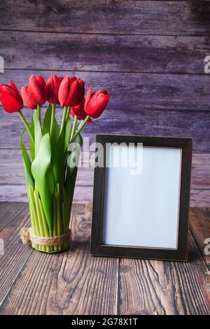 photo frame and tulip flower on table  Stock Photo