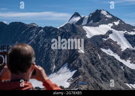 Europe, Austria, Tyrol, Stubai Alps, man view from the viewing platform Top of Tyrol on Zuckerhütl and Pfaffenschneid Stock Photo