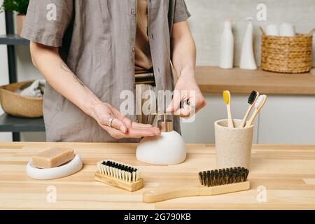 Woman applying liquid soap on hands before washing Stock Photo