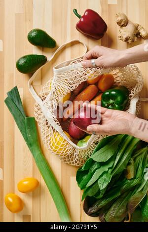 Hands of woman choosing onions for vegetarian salad Stock Photo