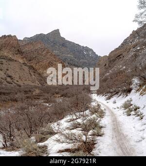 Provo Canyon snowy hiking trail in between the mountain slope at Utah Stock Photo