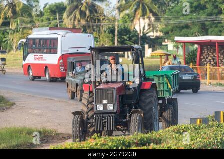 Cuban man driving an agricultural tractor on urban area,  Holguin, Cuba Nov. 2016 Stock Photo