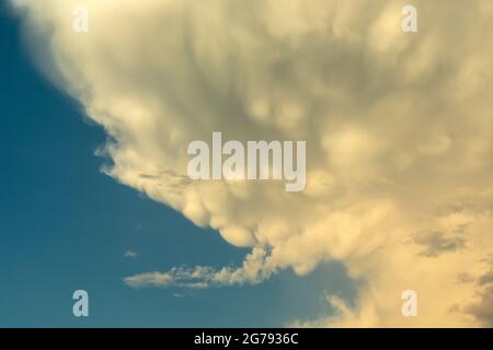 White-gray mammatus clouds against a blue sky, spring day Stock Photo