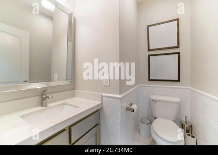 Interior of a bathroom with built-in sink with cabinet and mirror Stock Photo