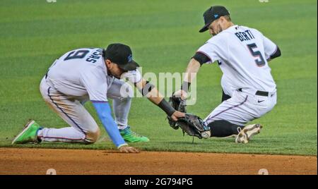 Surfside, USA. 08th July, 2021. Miami Marlins shortstop Miguel Rojas (19) and Miami Marlins third baseman Jon Berti (5) chase a ground ball hit by Los Angeles Dodgers second baseman Gavin Lux (9) in the ninth inning at loanDepot park in Miami on Thursday, July 8, 2021. (Photo by Al Diaz/Miami Herald/TNS/Sipa USA) Credit: Sipa USA/Alamy Live News Stock Photo