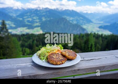 traditional local kaspressknodel cheese dumpling in tirol austria with mountain view landscape Stock Photo