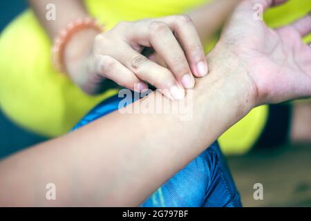 Trainer hands feeling pulse on female wrist. health care concept.Cross processing and Split tone new colour trend like process. Stock Photo