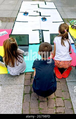 children control toy robots on a playground in the park,Sofia,Bulgaria, Stock Photo