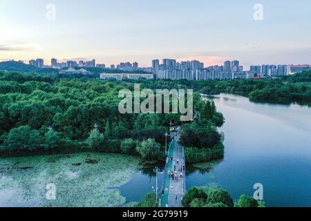 Guiyang. 7th July, 2021. Aerial photo taken on July 7, 2021 shows citizens walking at Guanshanhu Park in Guiyang City, southwest China's Guizhou Province. Credit: Yang Wenbin/Xinhua/Alamy Live News Stock Photo