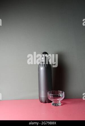 A still life with water bottle and desert cup. Stock Photo