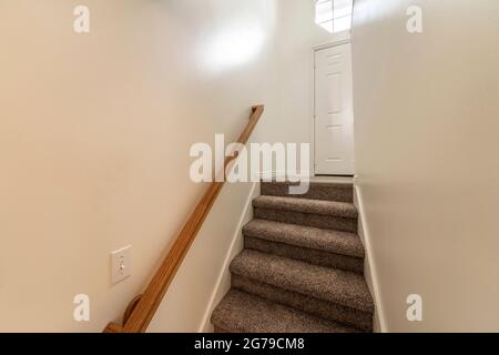 Interior of a basement stairs in a house with window and lights Stock Photo